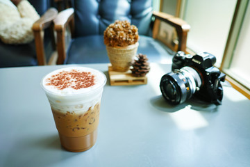 Ice Cappuccino in PET cup at cafe. Ice coffee in Vintage style cafe.