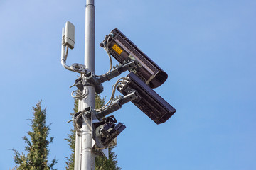 CCTV security camera and surveillance on a pole against the backdrop of blue sky