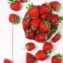 Strawberries on white wood