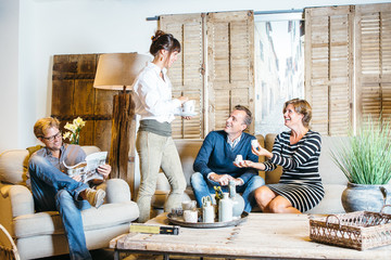 Cheerful friends enjoying tea at home