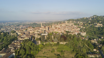 Fototapeta premium Drone aerial view of Bergamo - Old city. One of the beautiful city in Italy. Landscape on the city center, its historical buildings and towers during a wonderful blu day