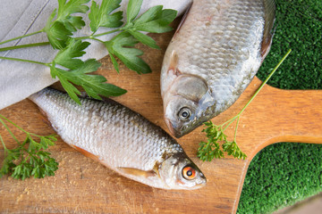 Fish on a wooden board, two raw fish