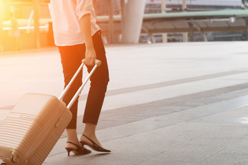 A woman are  pulling suitcase in the city