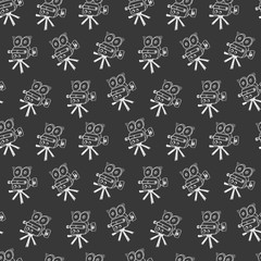 Seamless pattern background with doodle retro movie camera on a blackboard