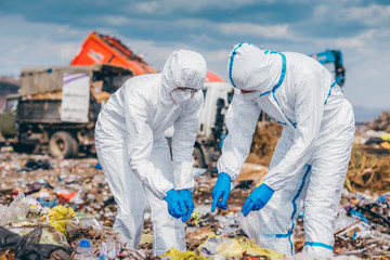 Recycling workers researching on the landfill