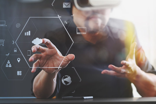 businessman wearing virtual reality goggles in modern office with mobile phone using with VR headset with screen icon diagram