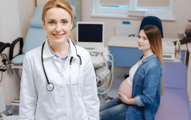 Delighted practitioner enjoying appointment hours in the clinic