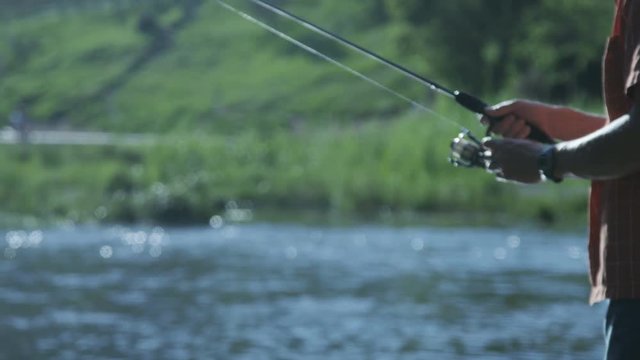 Man reeling in fishing line while fishing
