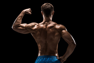 Fototapeta na wymiar Strong Athletic Man Fitness Model posing back muscles, triceps over black background