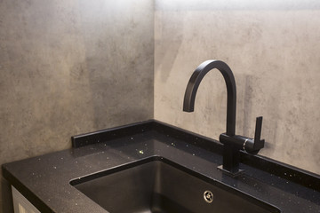 modern black water tab and square sink with concrete wall background in the dark room - laconic...