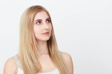 Closeup portrait of a beautiful young blond woman with clean face