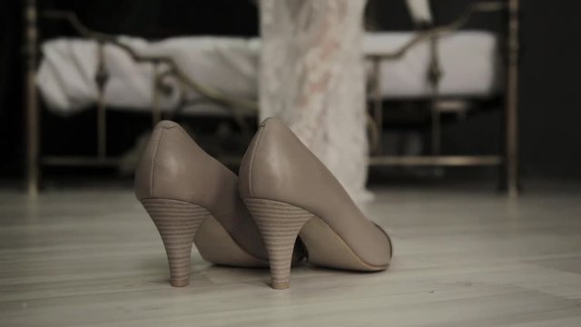 first wedding night. bride comes to a bed, removes shoes and lace dress