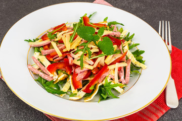 Meat salad with arugula, ham