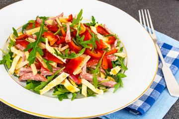 Meat salad with arugula, ham