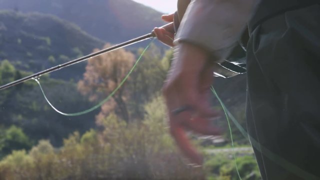 close up of hand casting while fishing