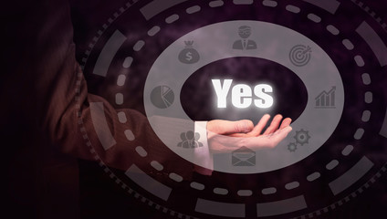 A hand holding a Yes Concept