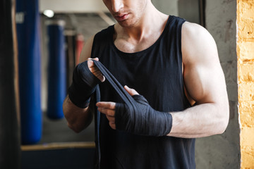 Cropped image of man wearing gloves for boxing