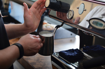 Barista prepares a cup of coffee cappuccino