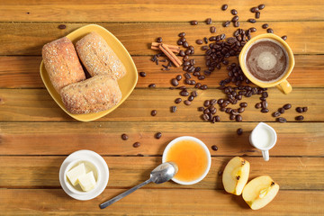 Crispy rolls with butter, apple jelly and hot coffee for breakfast