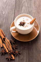Masala chai with spices cinnamon , cardamom, ginger, clove and star anise on wooden background