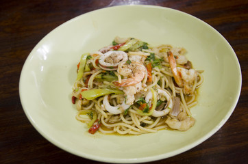 Spaghetti fried spicy mixed seafood with chilli and Basil leaves thai style