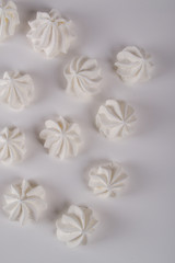 Closeup of mini meringues cookies on white background