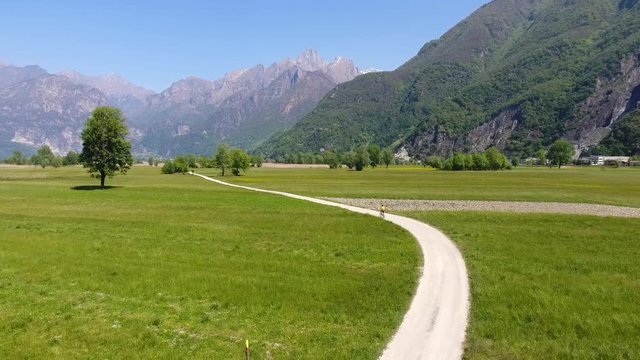 Cyclist on pathway - Natural reserve in Valtellina