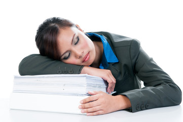 Tired female office worker falling asleep on pile of documents over white background