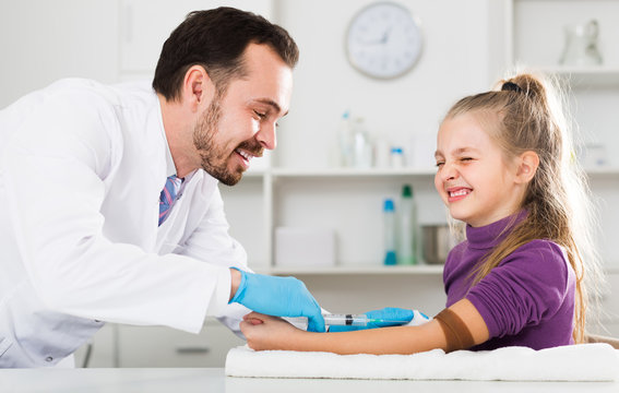 Male Doctor Ready To Make Injection To Visitor