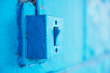The old switch in the web on the blue brick wall. Vintage