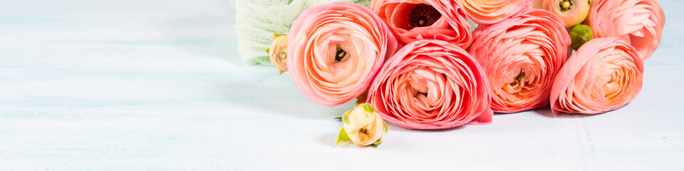Beautiful pink ranunculus bouquet on turquoise background. Woman mother's day wedding. Holiday elegant bunch of flowers. Banner