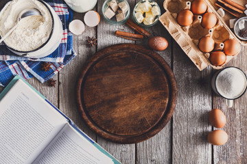 Baking ingredients on rustic wood background