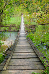 Obraz premium Old wood bridge crossing a river