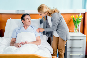 Fototapeta premium wife visiting her middle aged husband in hospital