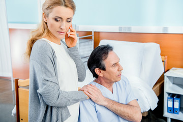 Obraz premium wheelchair man with wife near by in hospital chamber