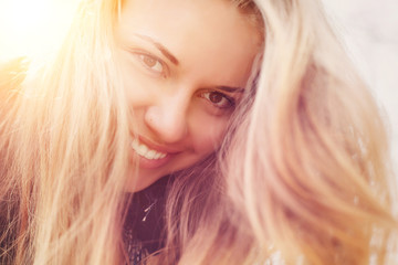 Beauty Sunshine Girl Portrait. Happy Woman Smiling and looking at the camera.