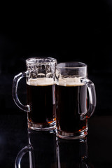 Two mugs of dark beer