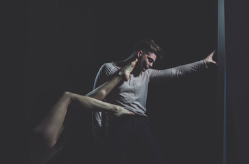 Handsome man posing with sexy, female legs on back