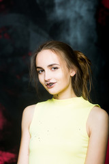 Fototapeta premium pretty dirty smiling girl painter at painted wall in black