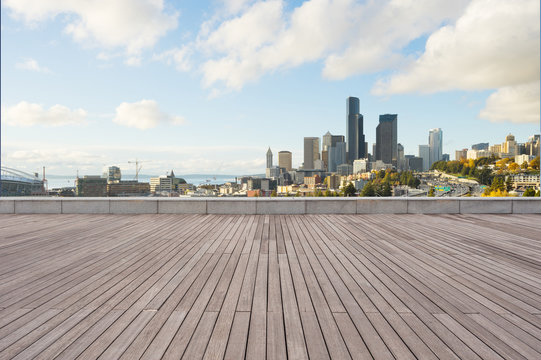empty wooden floor with cityscape of modern city