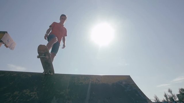 The boy is standing on the ramp and then he starts skating.HD