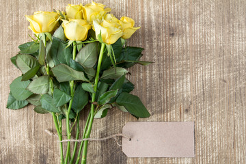 Bunch of yellow roses with blank tag