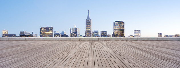 Fototapeta premium empty wooden floor with cityscape of modern city