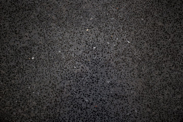 Modern black stone floor close up background.