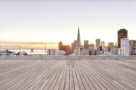 empty wooden floor with cityscape of modern city