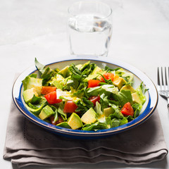 Healthy avocado spinach tomato salad. Gourmet dieting
