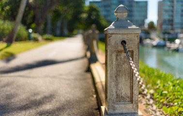 A harbor side promenade with bollards connected with chains in Townsville, Queensland, Australia.