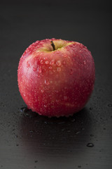 Pink lady apple on black background 