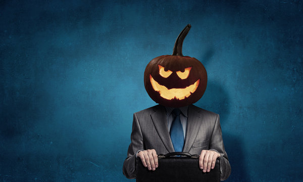 Scary businessman with pumpkin head