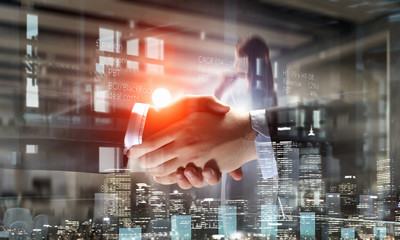 Partners shaking hands as symbol of deal